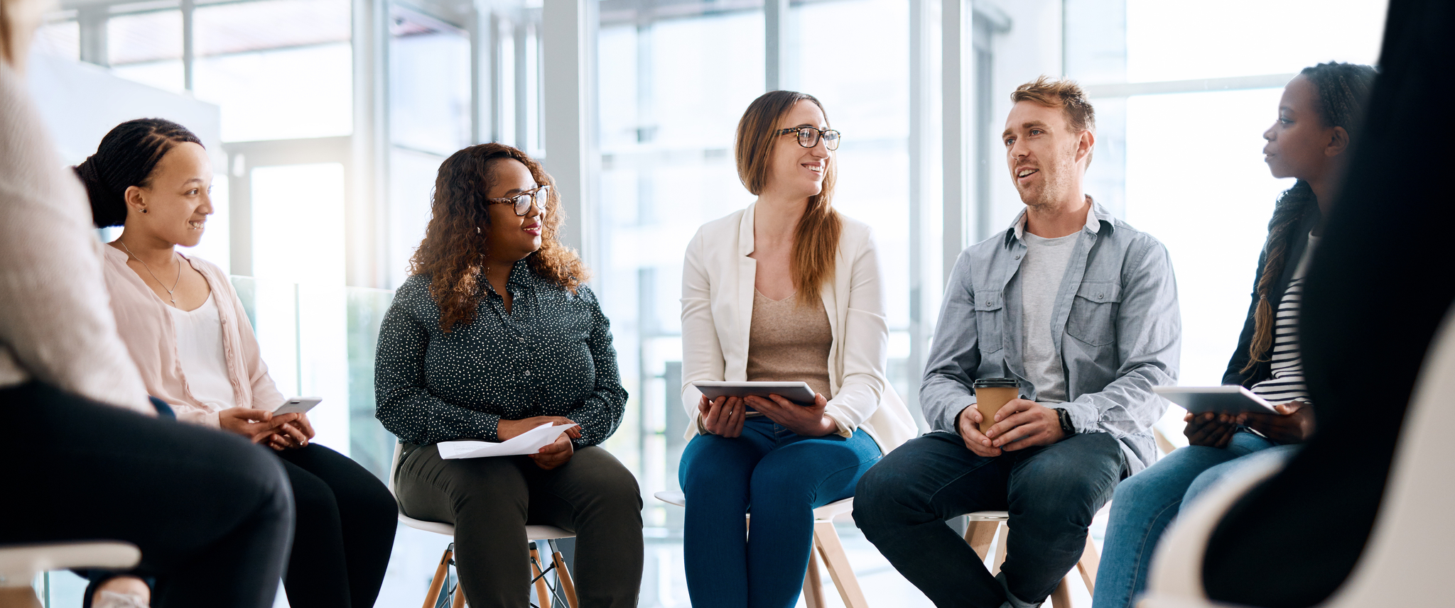 Group of people sitting in a circle and having a meeting