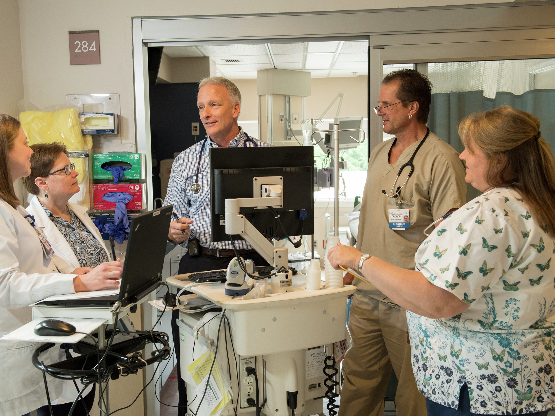 Male and female providers discussing a health topic in a hospital area