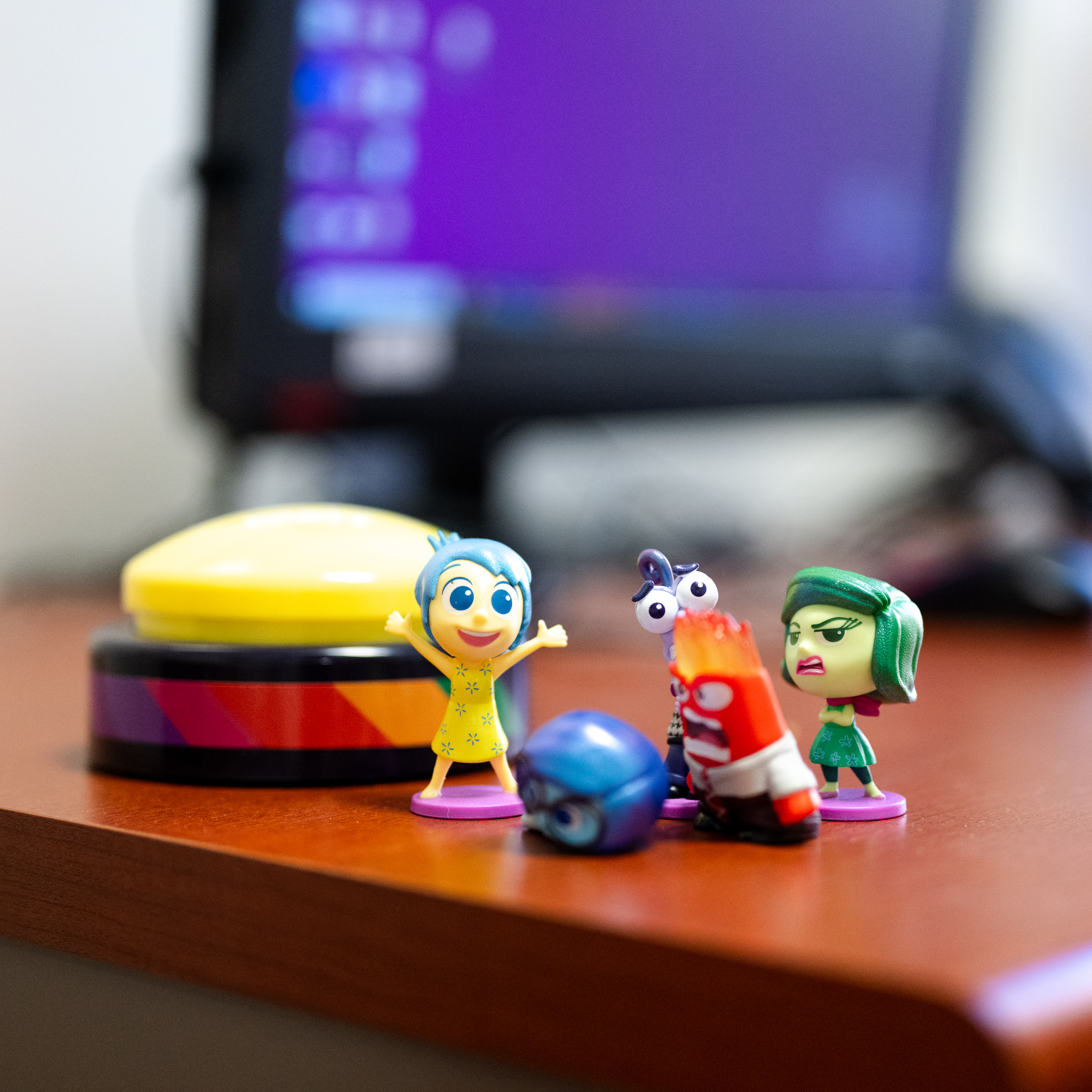 Close up on toy figures of the emotion characters from the movie Inside Out 2, on an office desk