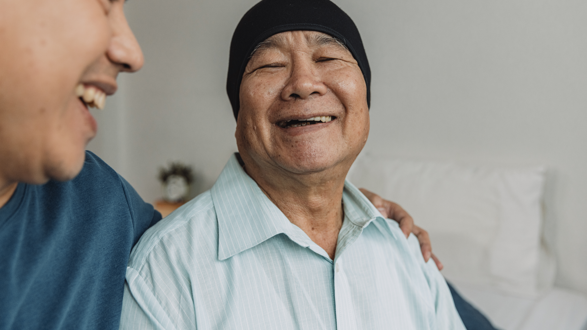 Father and son enjoy talking in bedroom