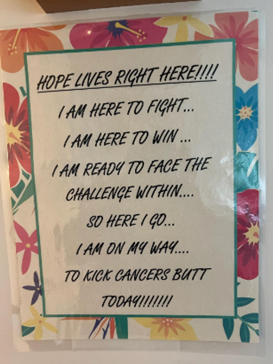 A poster of an inspirational poem about cancer on it with a floral background.