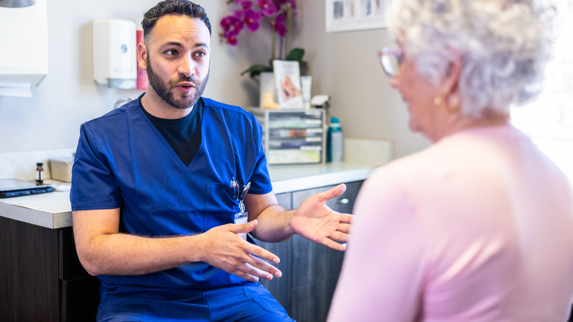 Senior consulting with doctor in exam room