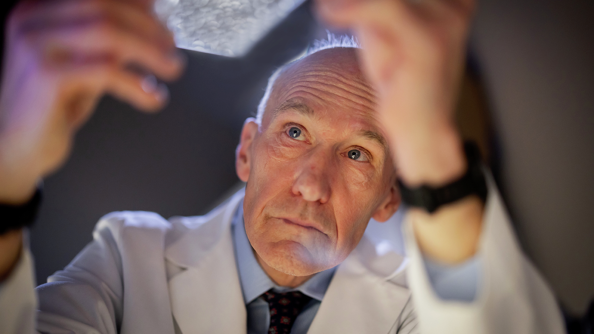 Dr. Carl June looking at specimen in a lab