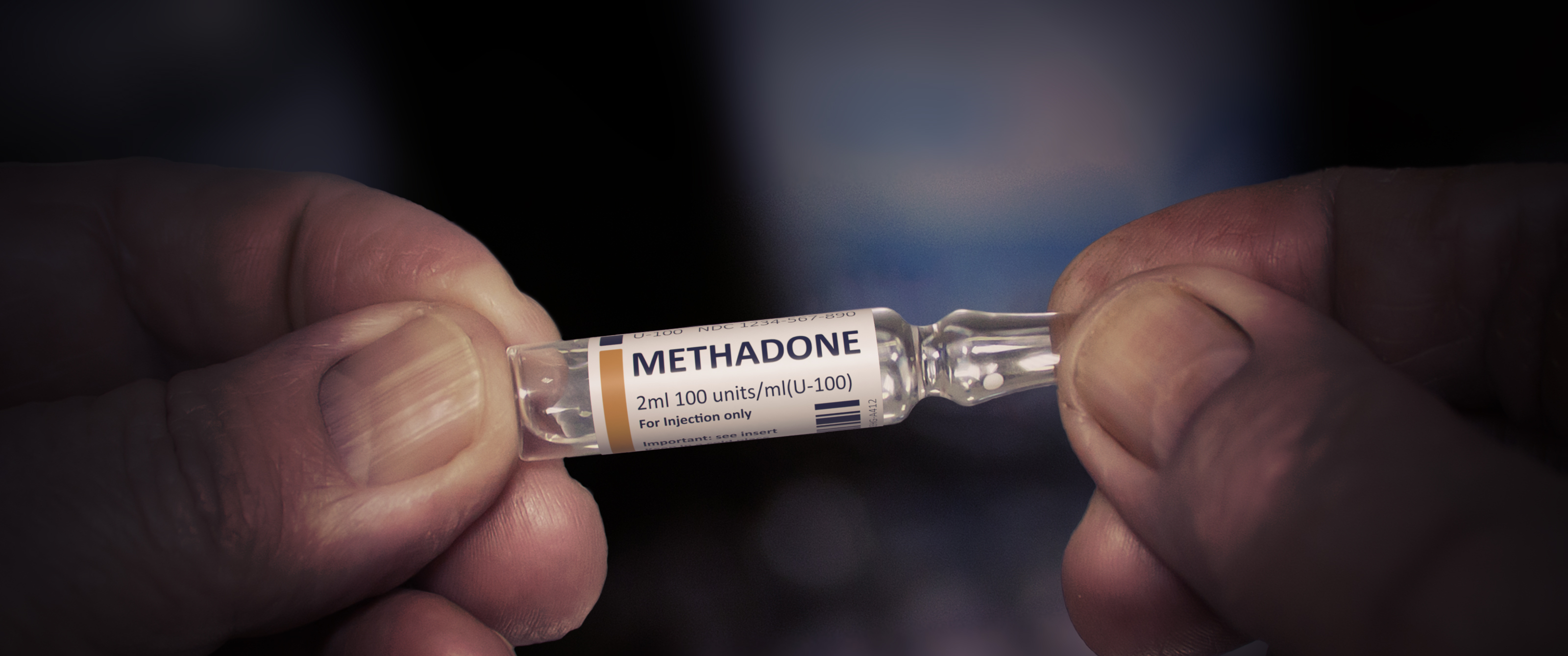 An ampoule of methadone in a doctor's hands