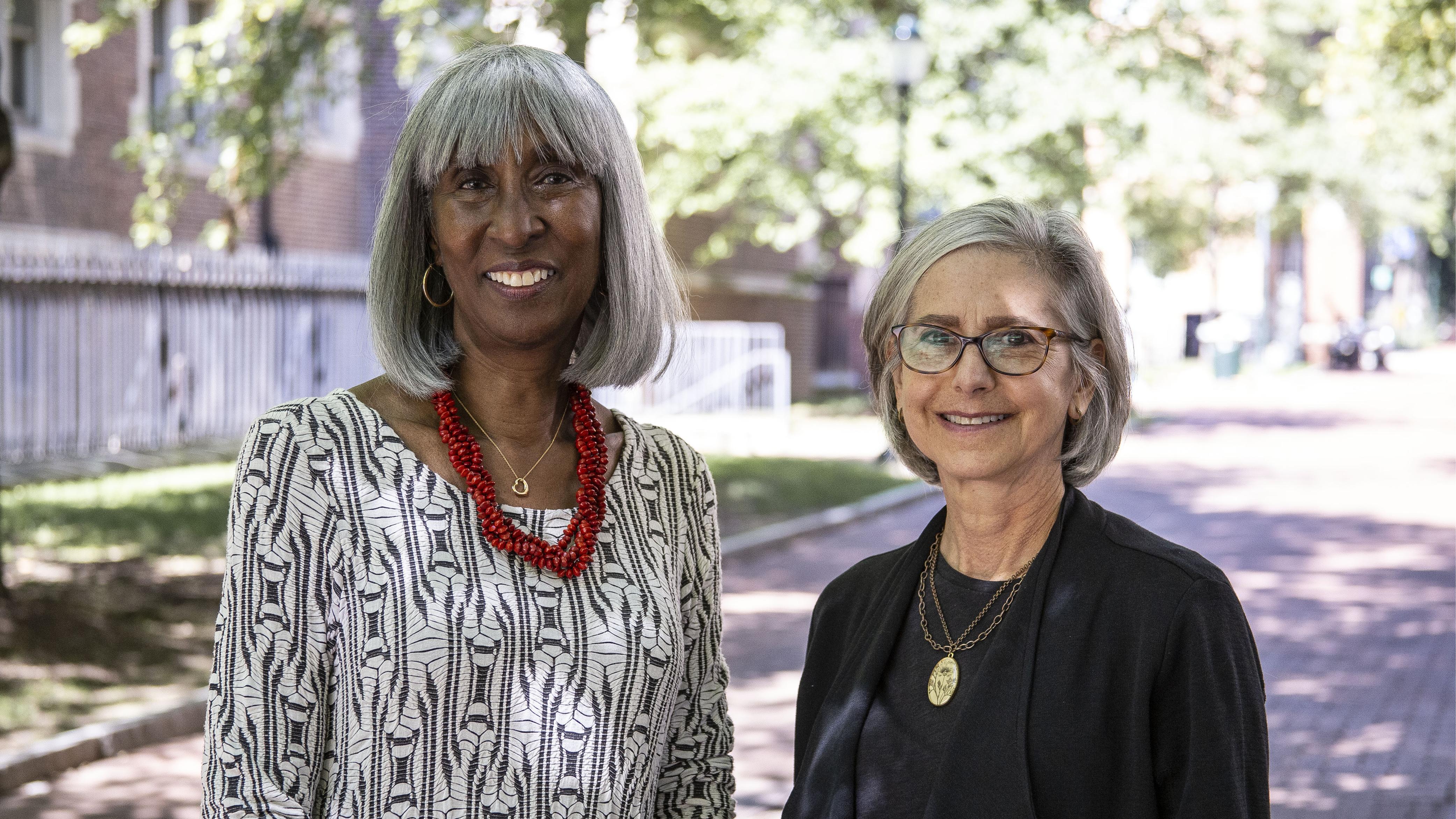 A portrait of Carol Benenson Perloff with Jayne Henderson Brown, standing outdoors