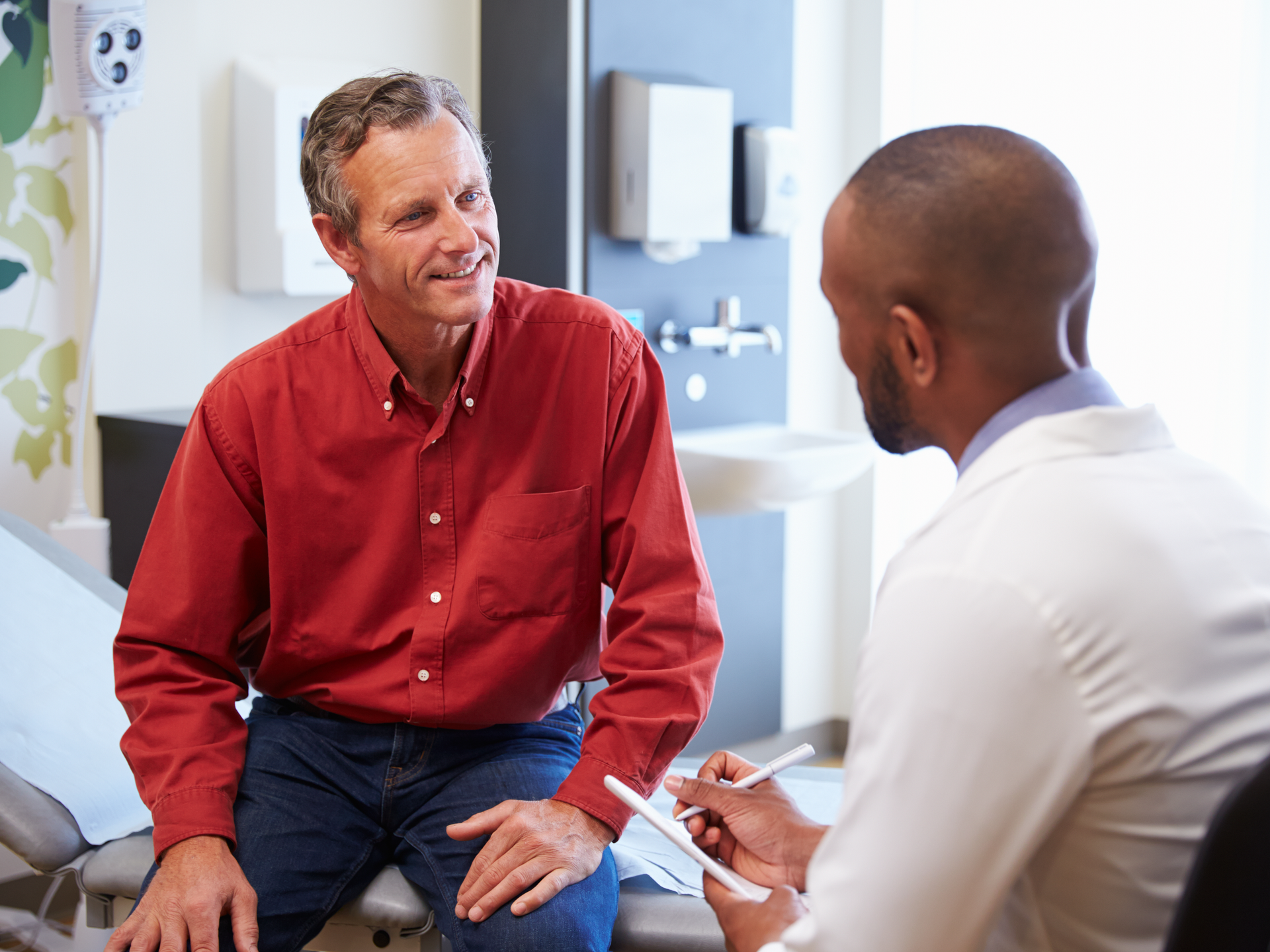 Male patient and doctor have consultation In hospital room
