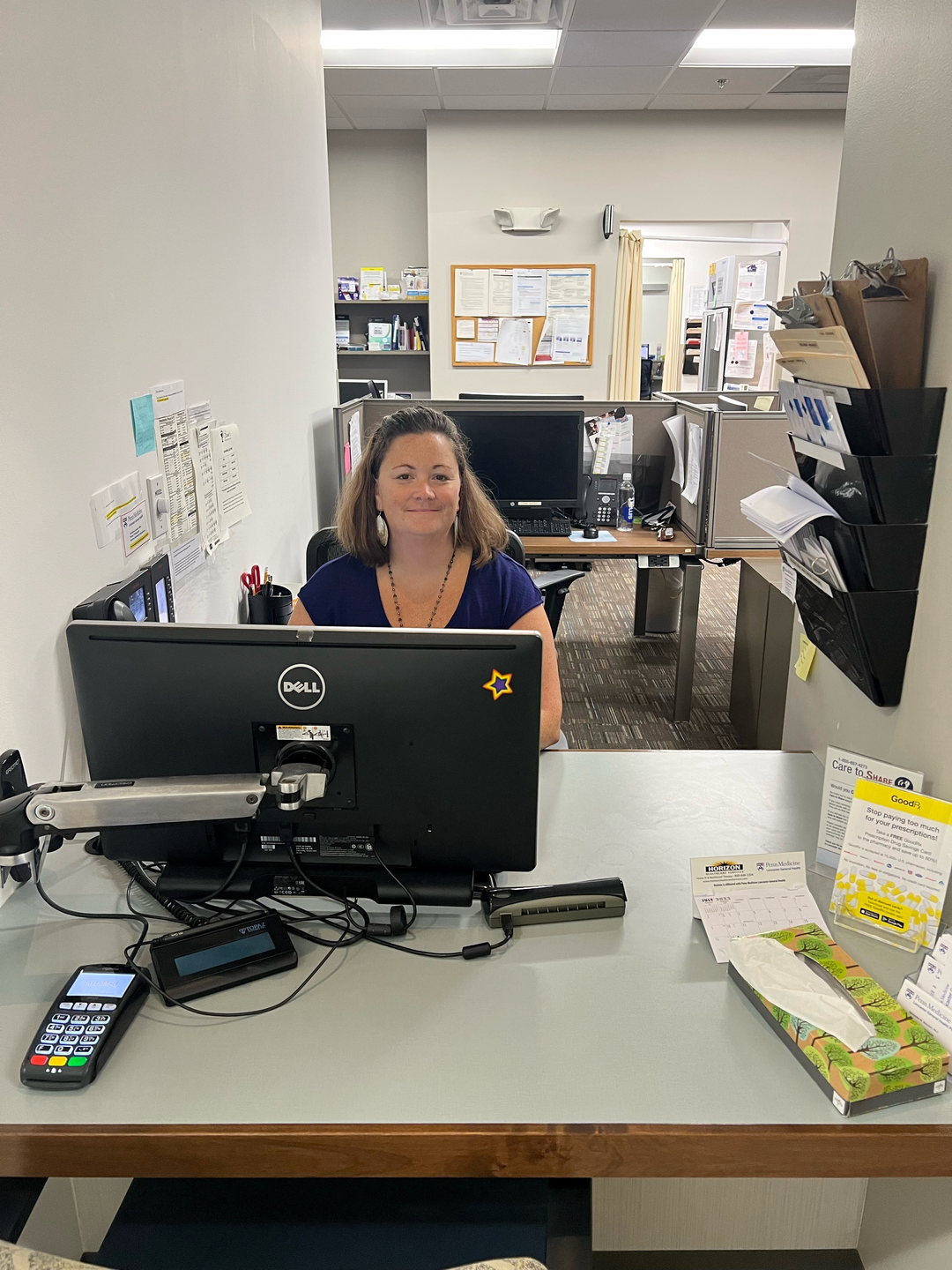 Heather Landis, seated behind a computer monitor in an office