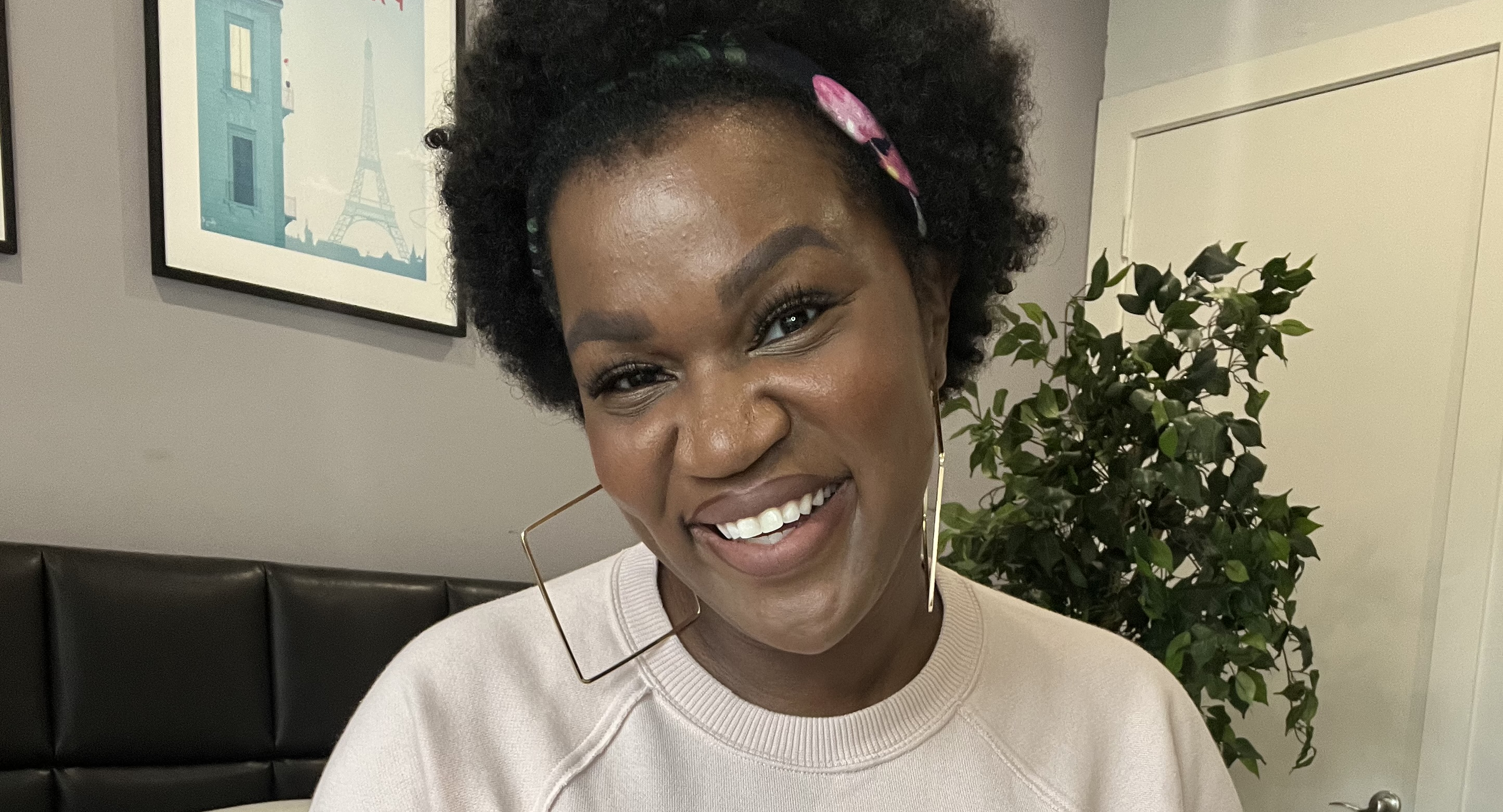 Brooklyn Olumba wearing a shirt with a minimalist line drawing of breasts on the front
