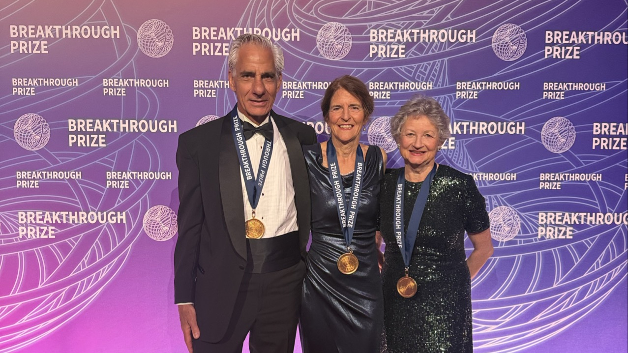 Albert Maguire, Jean Bennett, and Katherine High stand on a red carpet at the 2026 Breakthrough Prize event