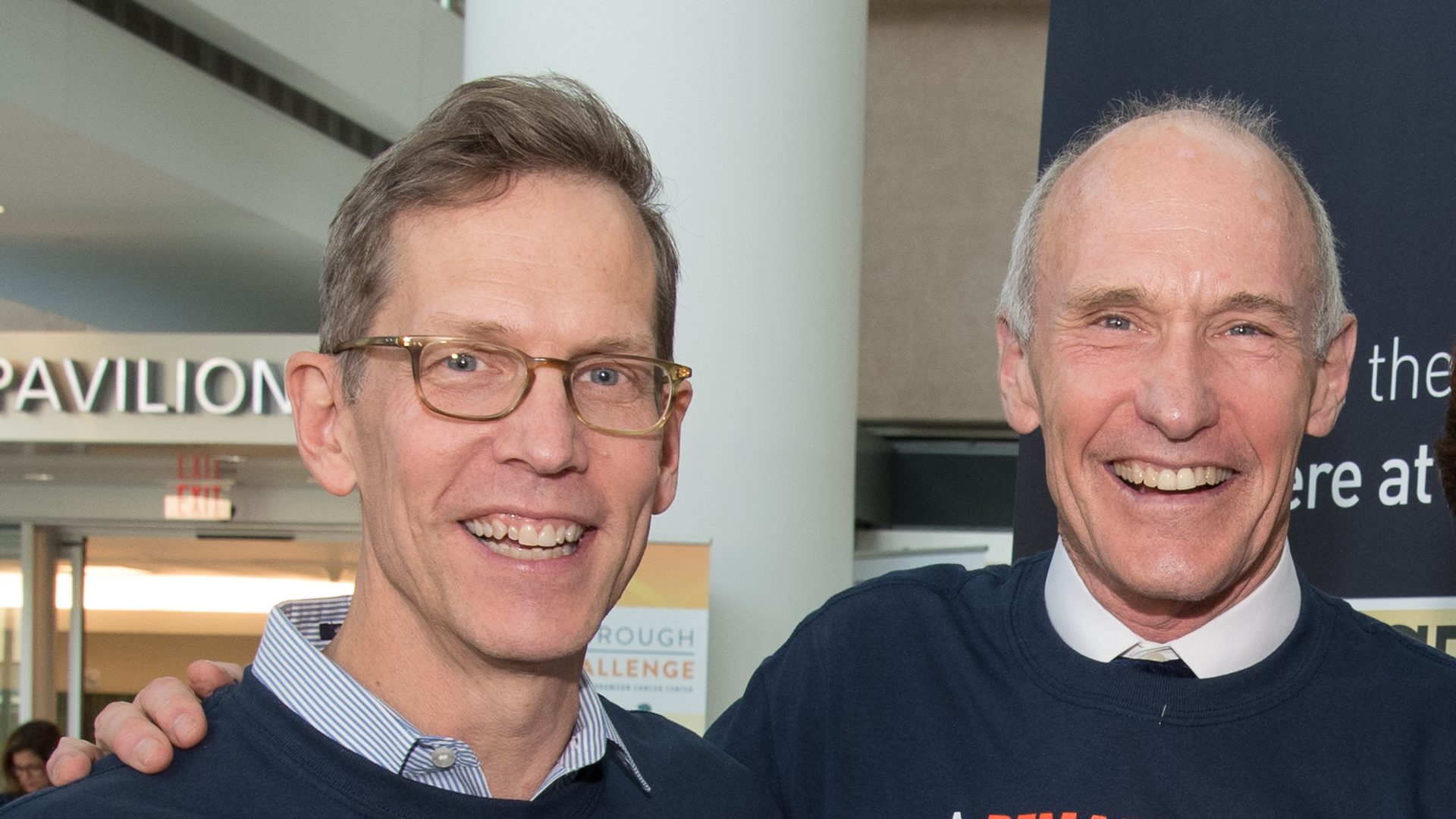 Robert Vonderheide and Carl June, both smiling widely, wearing matching T-shirts that say "A remarkable thing happened; FDA approval of CAR T cell therapy 2017"