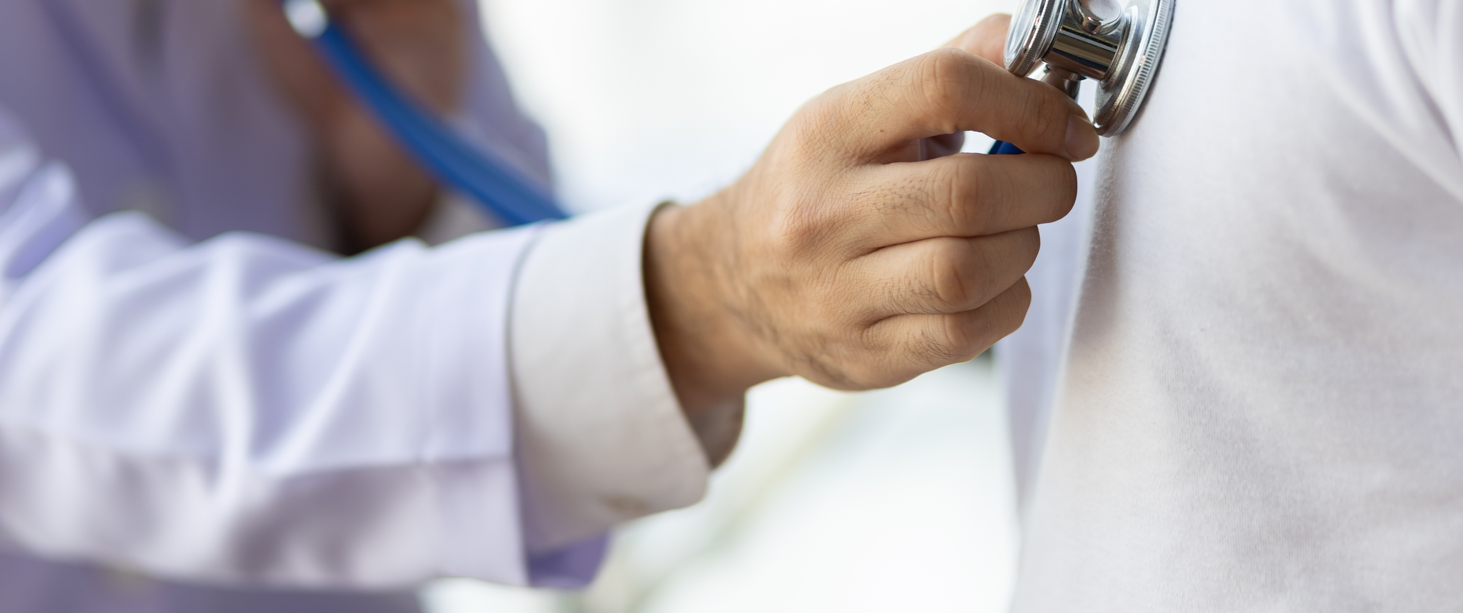Doctor uses stethoscope to examine patient