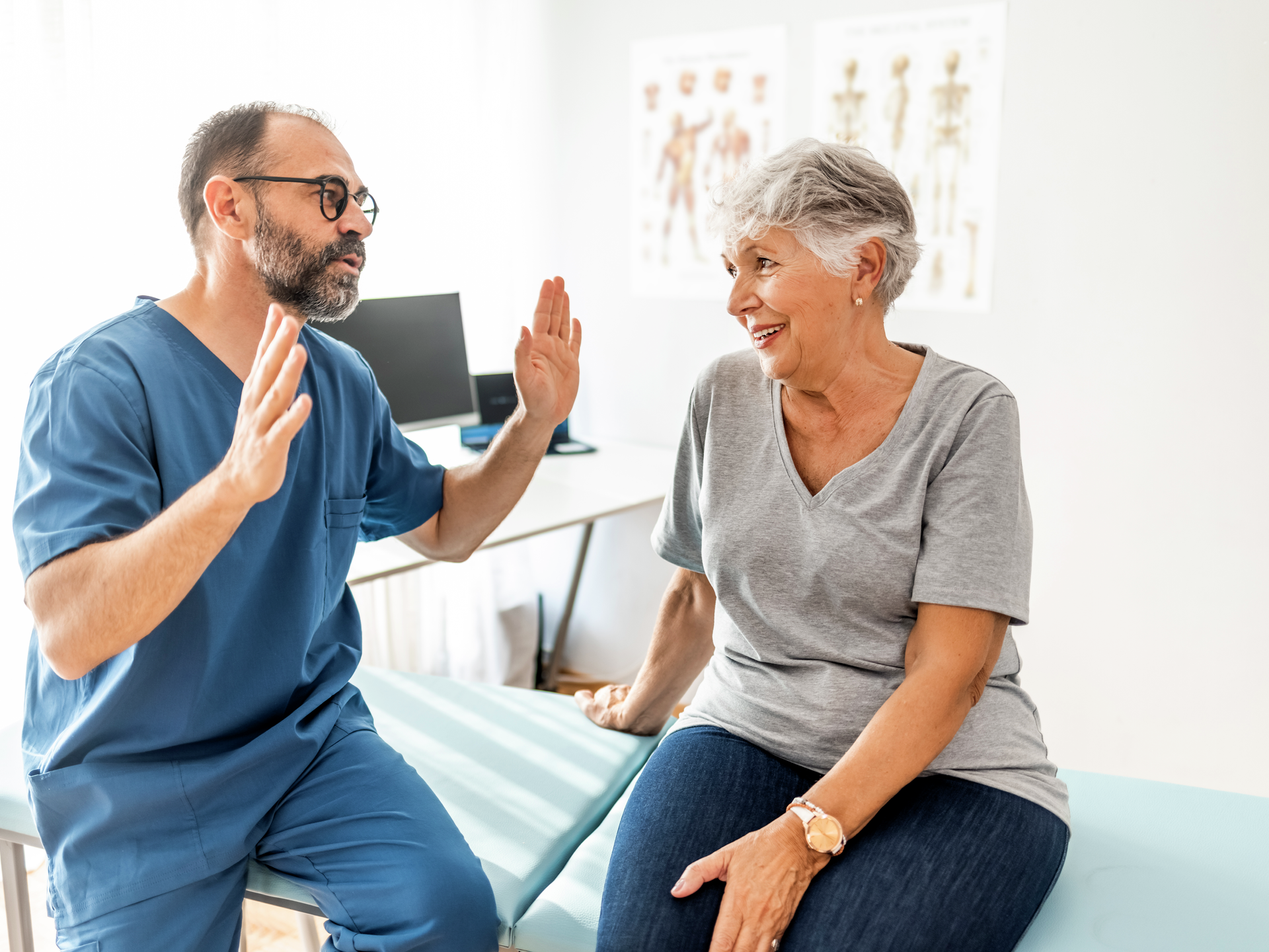 Cropped shot of mature male physiotherapist doing a consultation and assessment with a senior female patient