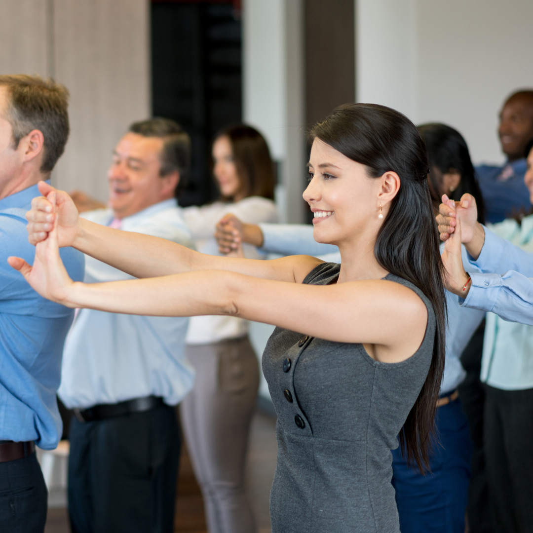 American business group at the office making a work pause and stretching