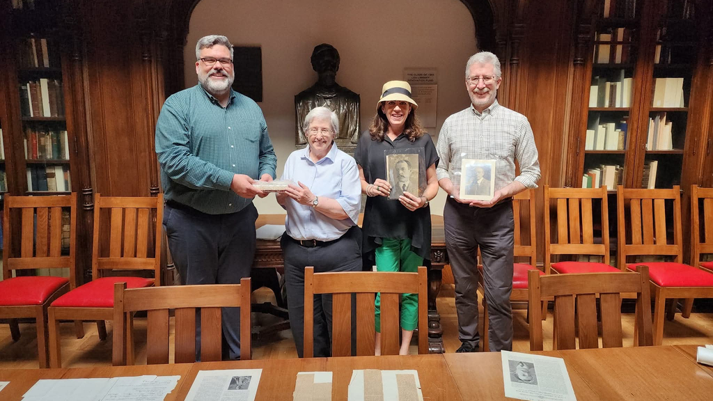 From left to right: University Archivist John Bence, Dianne Goodspeed Halliday, Sharon Goodspeed, and Assistant University Archivist Jim Duffin, with Halliday and Bence holding the box of 1896 X-ray plates