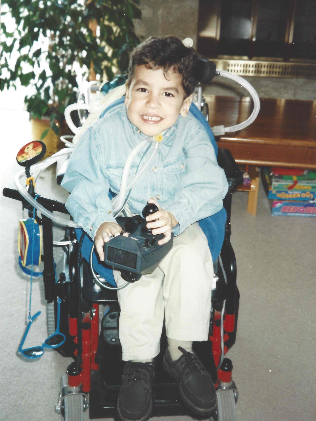 Alex Gardner as a young child in a wheelchair, smiling