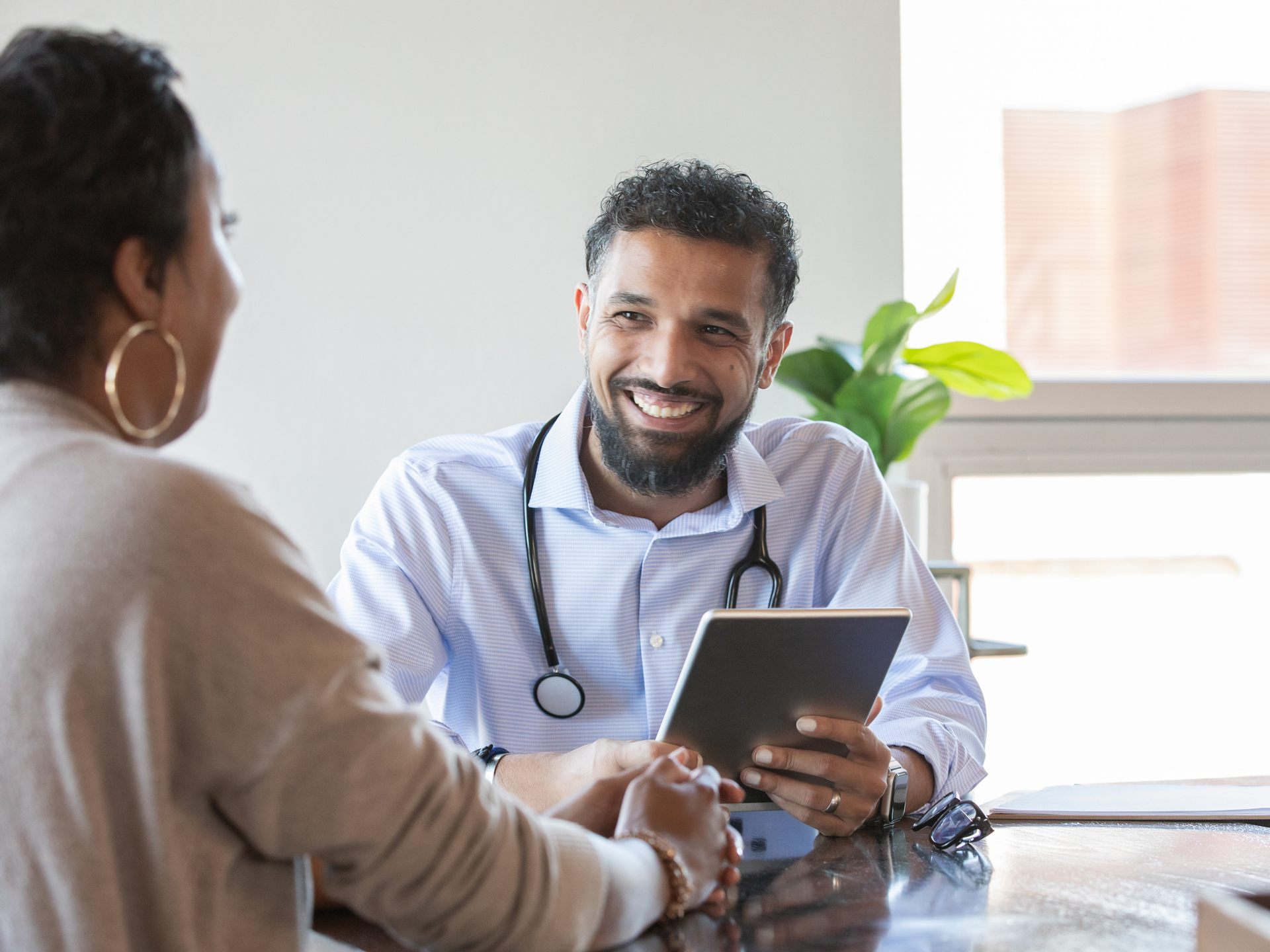 Doctor and Patient at appointment reviewing patient resources about epilepsy