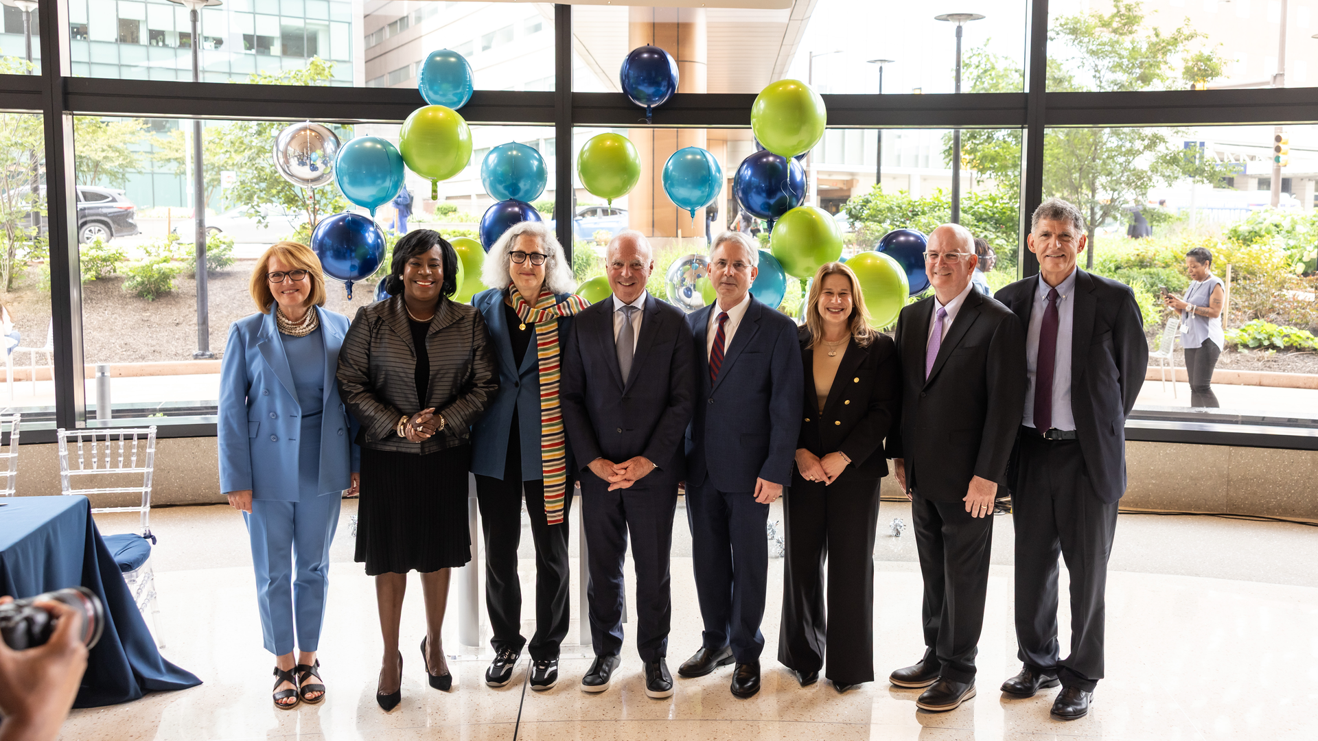 CHOP, Penn Medicine, the Lurie Family, City of Philadelphia, and Commonwealth of Pennsylvania leaders below a sign of the Lurie Autism Institute logo