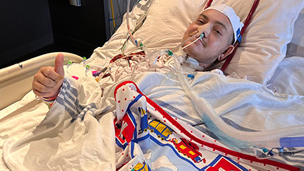 Photo of JP in a hospital bed before his surgery