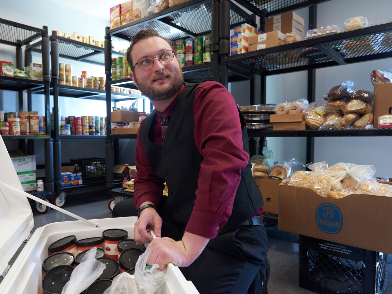 Christopher Moore looks up while unpacking items from a cooler