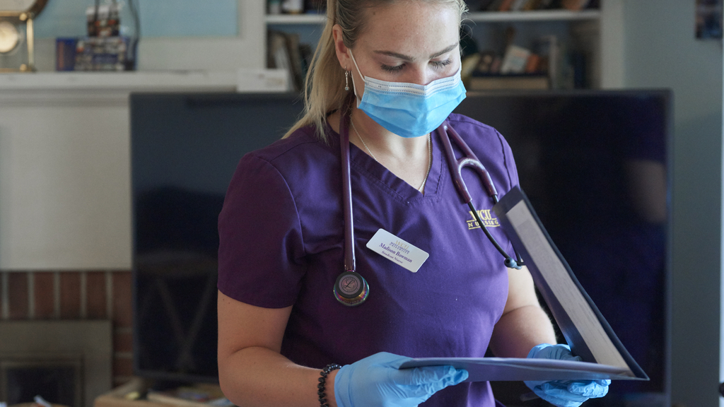 Student nurse Melissa Bowman looks at a folder