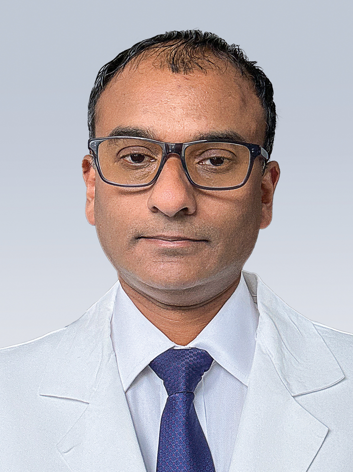 Headshot of Devraj Basu, MD, PhD, in white lab coat
