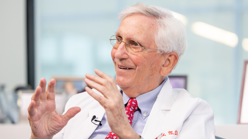 John Glick, smiling and wearing a white coat